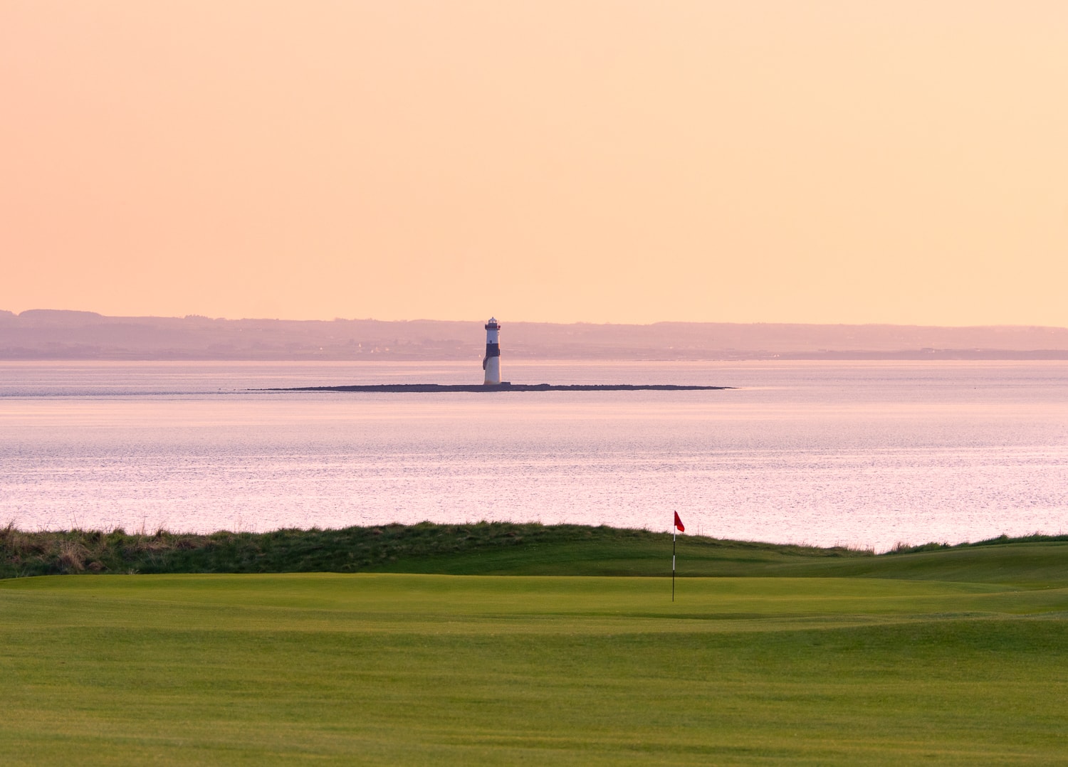 Oyster Island lighthouse at dusk from the fairways of County Sligo Golf Club